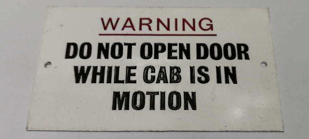 Sign – warning do not open door while cab